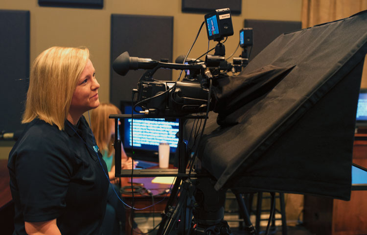 woman using video production equipment